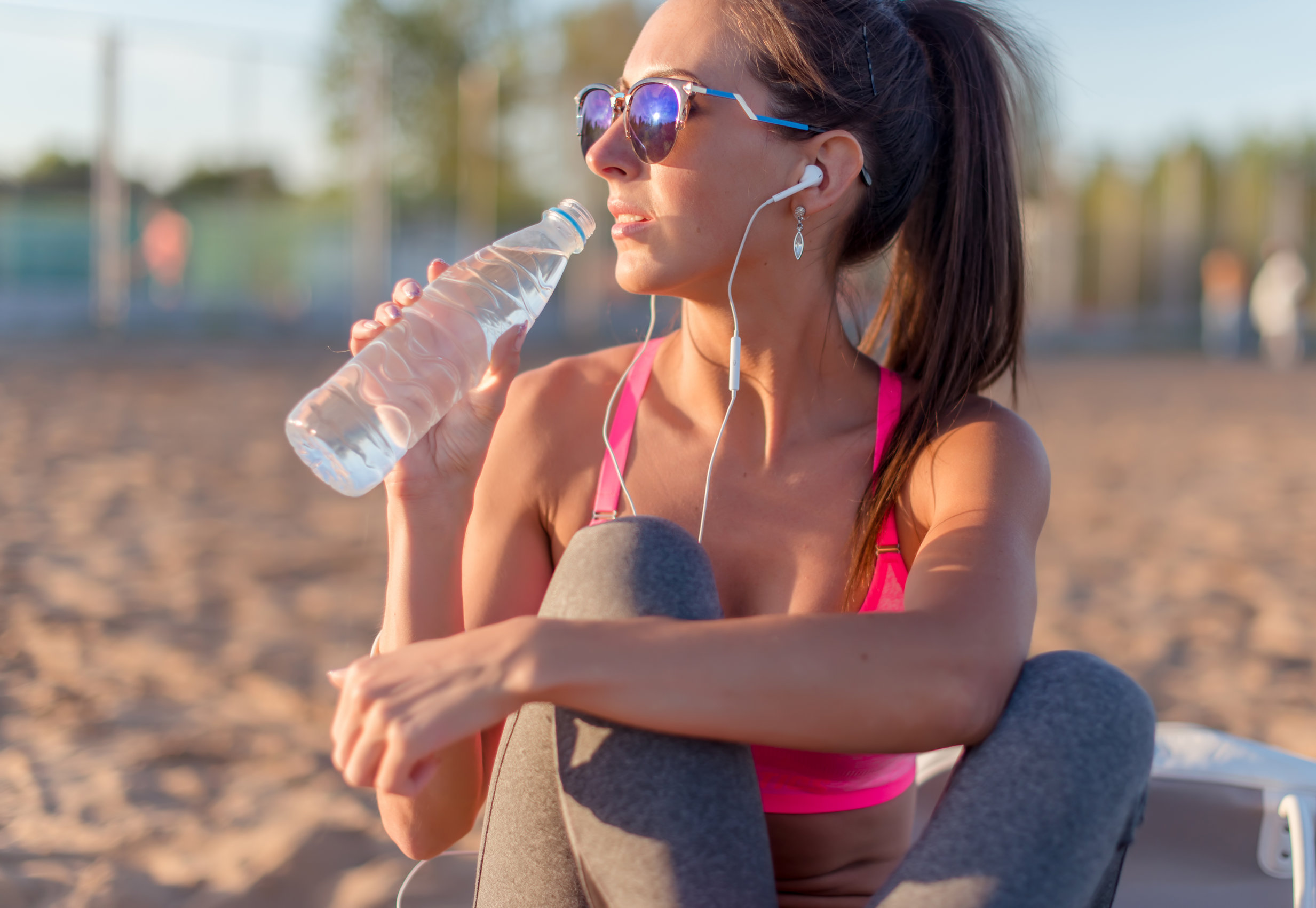 Woman drinking from smart water bottle