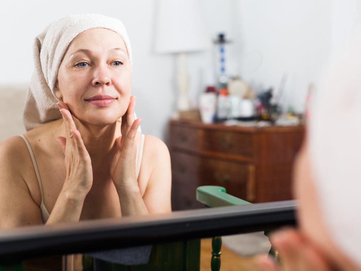 Mature woman applying face cream