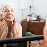 Mature woman applying face cream