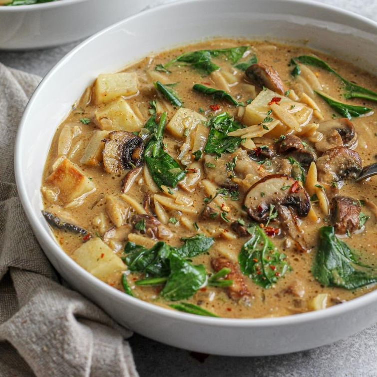 Delicious bowl of creamy mushroom spinach soup with orzo and potato