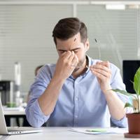 Tired businessman with eye strain