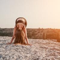 Woman stretching at sunset