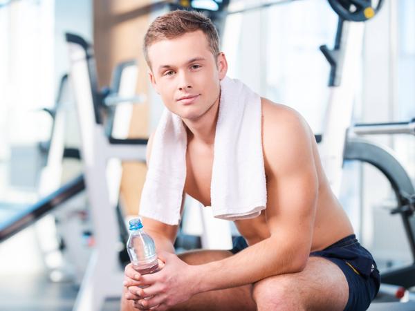Muscular man resting after workout