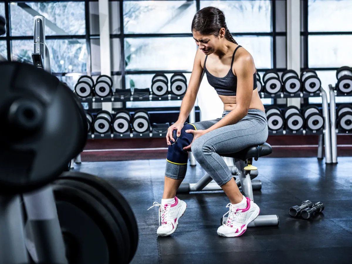A determined athlete takes a moment to recover, reflecting on her journey and the challenges ahead. With a focus on resilience, she prepares to push through the pain and continue her fitness goals at the gym.