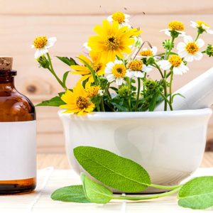 A tranquil herbal remedy setting featuring a beautifully arranged mortar and pestle filled with vibrant wildflowers, accompanied by a vintage glass bottle. This scene evokes a sense of natural wellness and holistic healing, perfect for those seeking a connection with nature and the benefits of herbalism.
