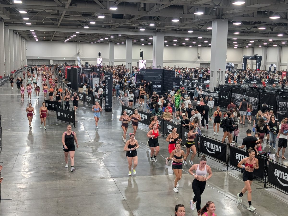 Runners circling the lanes at the Salt Palace Convention Center during HYROX Salt Lake City