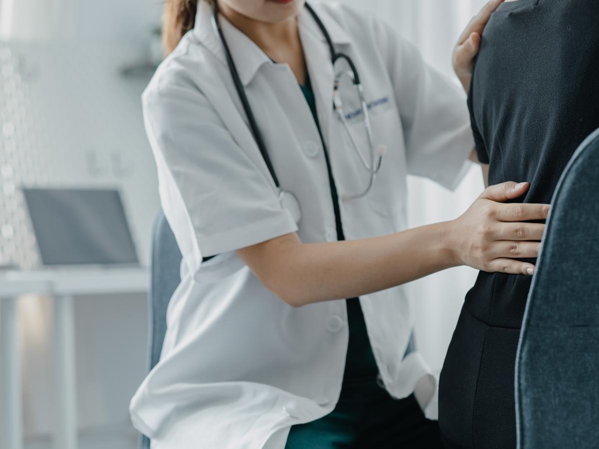 Physiotherapist treating patient with body aches