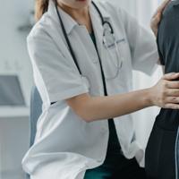 Physiotherapist treating patient with body aches
