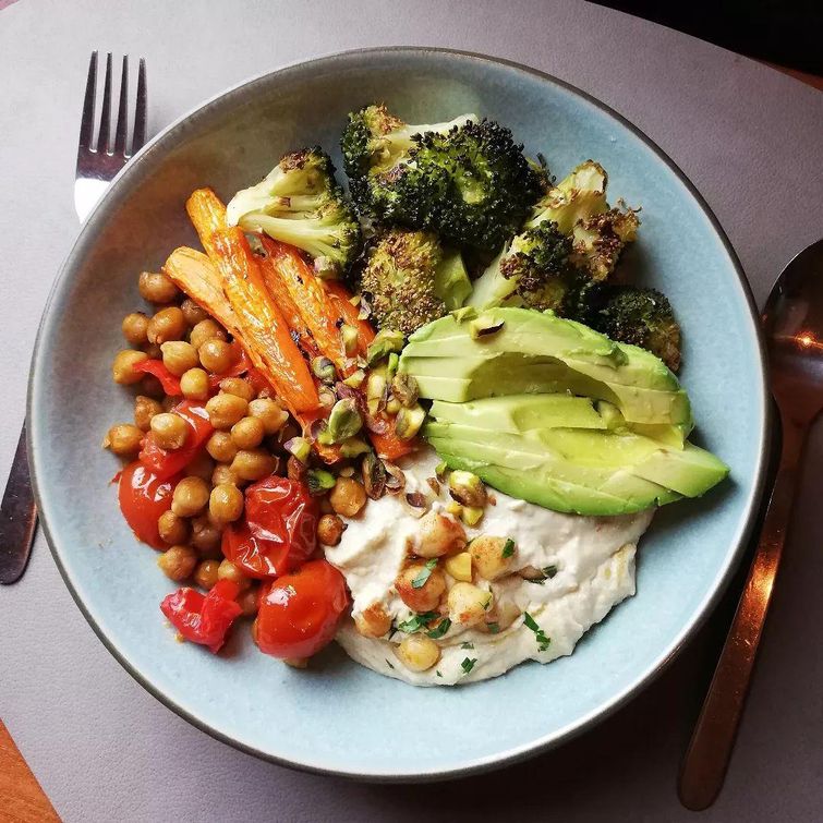 Quinoa veggie bowl with hummus, avocado, and harissa roasted chickpeas