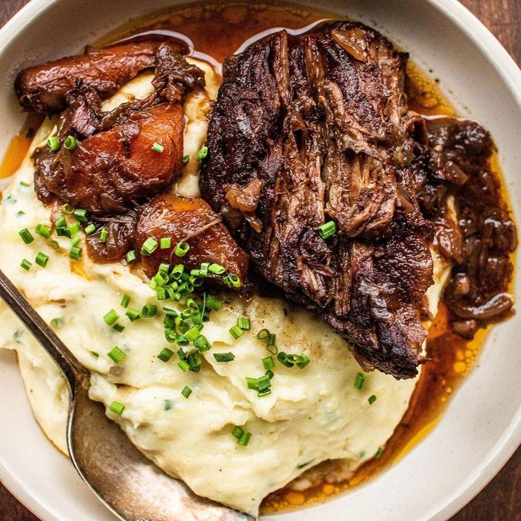 Delicious braised beef over mashed potatoes