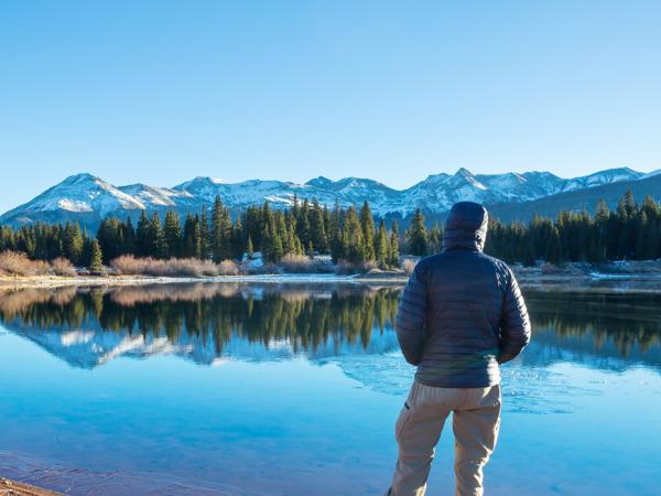 Man resting by calm lake