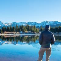 Man resting by calm lake
