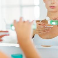 Woman applying facial toner