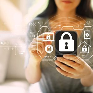 In a world increasingly reliant on technology, a woman interacts with her smartphone, engaging with digital security icons that symbolize the importance of protecting personal information and homes. This scene highlights the intersection of modern life and cybersecurity, reminding us that safety begins with our devices.