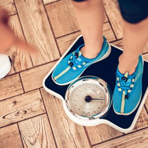 Woman standing on a smart scale