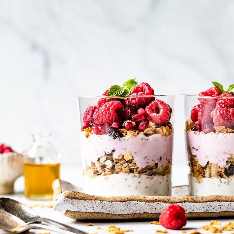 Colorful yogurt granola bowl with summer fruits