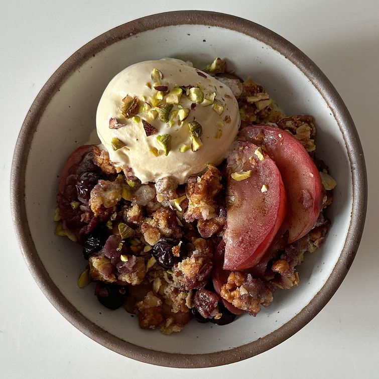 blueberry almond crisp with ice cream and pistachios