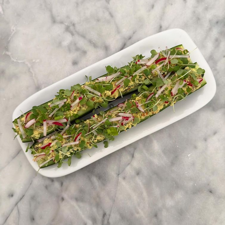 Vegan eggless salad stuffed cucumbers with arugula