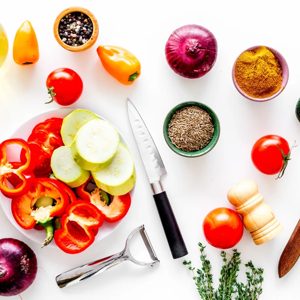 A vibrant display of fresh vegetables and spices, perfect for inspiring culinary creativity. This colorful arrangement features a variety of peppers, tomatoes, and herbs, inviting food enthusiasts to explore new recipes and flavors.