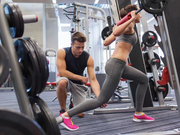 Personal trainer and client weightlifting