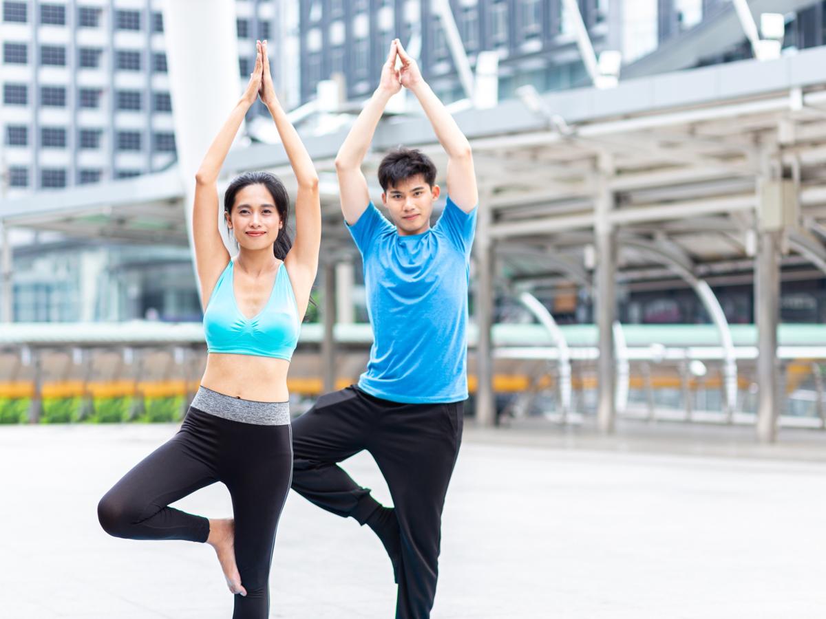 Man and woman practicing yoga