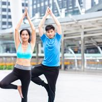 Man and woman practicing yoga