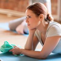 Woman resting on yoga mat