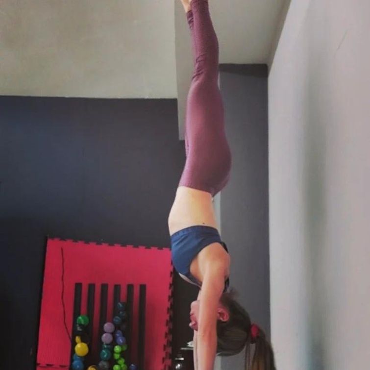 Yoga teacher performing handstand