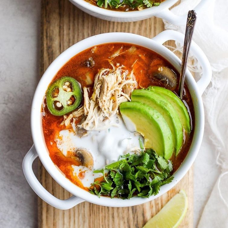 Delicious slow cooker white chicken chili topped with avocado and cilantro