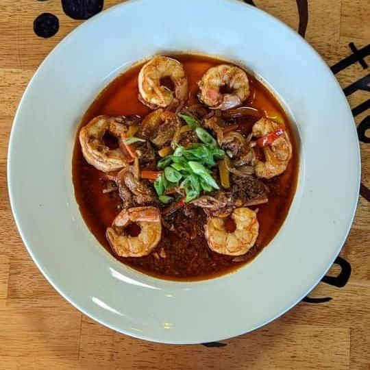 Shrimp and grits with sausage and creole gravy