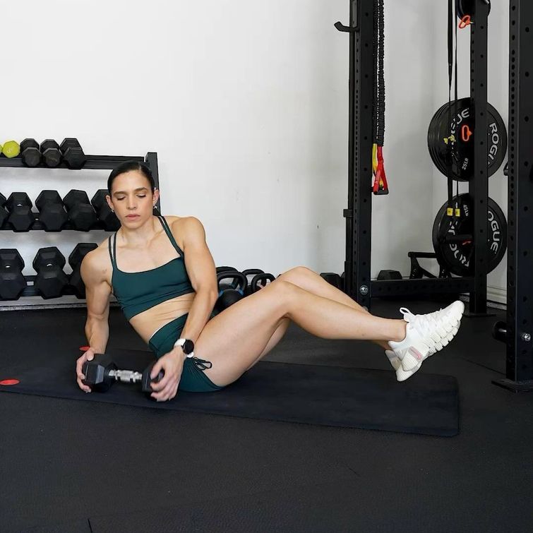 Woman doing ab workout with dumbbells