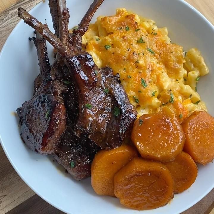 Delicious jerk lamb cutlets with mac and cheese and candied yams