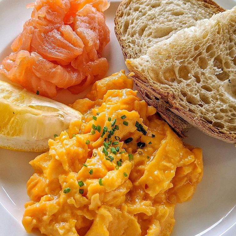 Healthy breakfast of smoked salmon and scrambled eggs