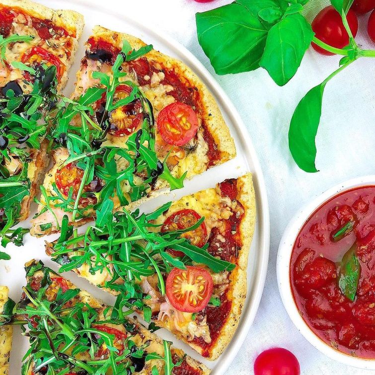 Gluten-free pizza with lean cheese, turkey, tomato, and arugula toppings