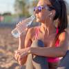 Woman drinking from smart water bottle