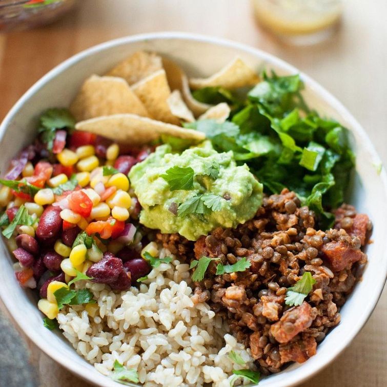 Homemade burrito bowl with lentil walnut taco meat, corn kidney bean salad, and guacamole