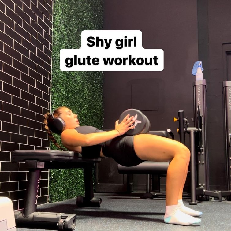 Girl performing glute workout with dumbbells