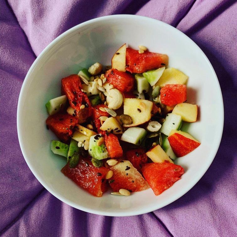 Colorful fruit and nut salad in a bowl