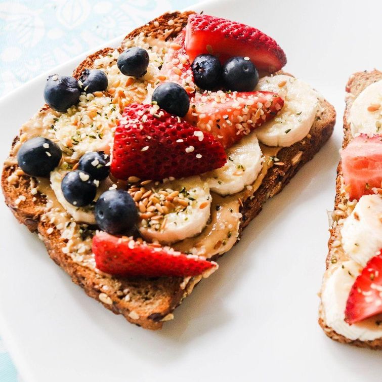 Peanut butter toast with fruits and seeds