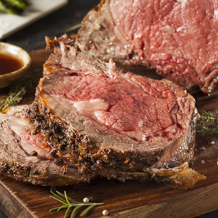 Prime rib dinner with baked potato and asparagus